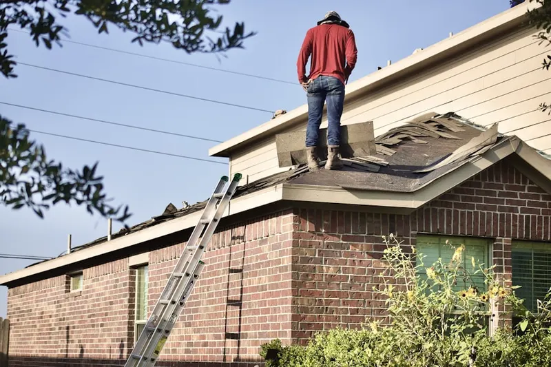 Professional roofer working on a residential roof in Woods of Shavano